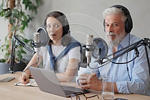 female and male podcasters record audio content in sound studio. social media, news program on radio