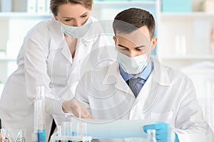 Female and male scientists working in laboratory