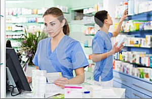 Female and male specialist are attentively stocktaking medicines