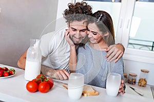 Female and male vegeterians stand together against kitchen interior, prepare salad. Family couple cook on cozy kitchen, husband