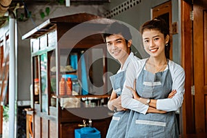 female and male waiters smiling with hands crossed