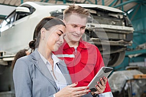Female manager and car mechanic while working in auto repair shop, Woman at a car garage getting mechanical service, Car repair
