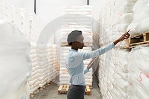 Female manager with digital tablet checking stocks in warehouse