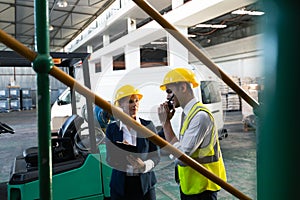 Female manager and male supervisor working together in warehouse
