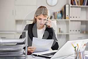 Female manager talking on phone in office