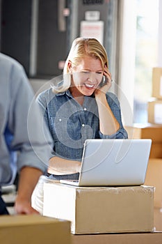 Female Manager Using Mobile Phone In Distribution Warehouse