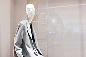 Female mannequin in gray jacket close up