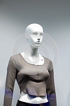 Female mannequin in gray jacket close up