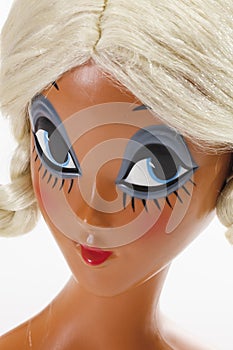 Female mannequin head wearing blonde wig with plaits