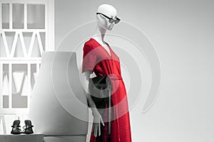 Female mannequin portrait in sunglasses and red dress. Sale and advertising theme. Copyspace for text