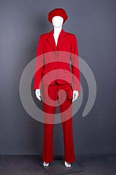 Female mannequin in red outfit.