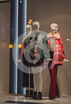 Female mannequins in a shop window on the coat