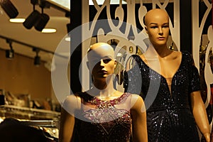 Female mannequins wearing sparkly evening dress.