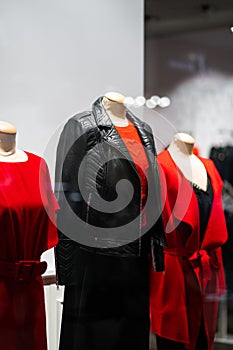 Female mannequins in a women`s store in store window show autumn winter collection . Standing women dummies show casual