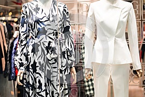Female mannequins in a women's store in store window show autumn winter collection . Standing women dummies show casual style