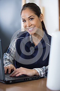 female manual worker using laptop