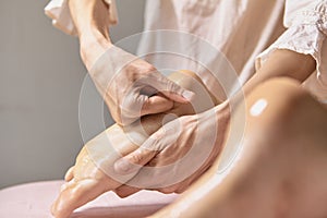 A female massage therapist doing a massage