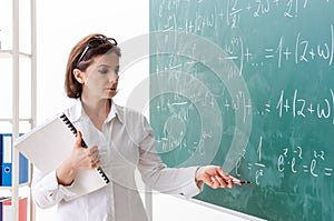 The female math teacher in front of the chalkboard