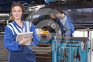 Female mechanic in car garage