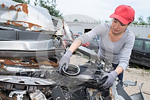 Female mechanic fixes engine