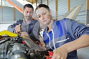 female mechanic using wrench to undo bolt on aircraft component