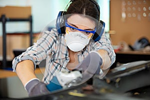 female mechanic working on car