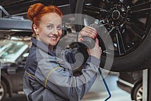 Female mechanic working at car service station