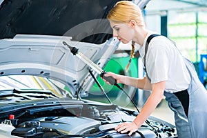 Female mechanic working in car workshop