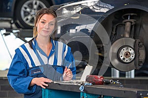 Female mechanic working on a MOT test