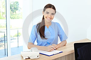 Female medical assistant at workplace in clinic photo