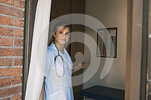 Nurse opening door in hospital photo