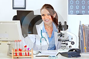 Female medical doctor sitting with roentgen photo