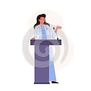 Female medical doctor standing at podium and giving a speech at a medicine conference. Presentation scientific research