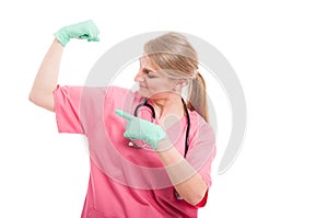 Female medical nurse showing her biceps wearing scrubs