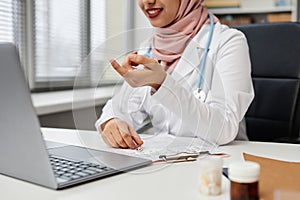 Female Medical Practitioner in Hijab Consulting Online