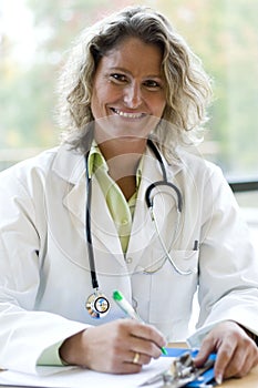 Female medical professional writing