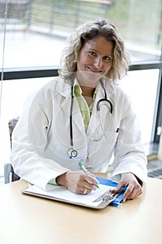 Female medical professional writing