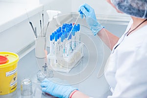 Female medical or scientific laboratory researcher performs tests. Close up, selective focus