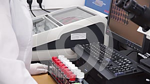 Female medical or scientific researcher using test tubes on laboratory. Clip. Female Scientist Analyzes Liquid in the