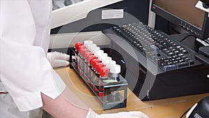 Female medical or scientific researcher using test tubes on laboratory. Clip. Female Scientist Analyzes Liquid in the