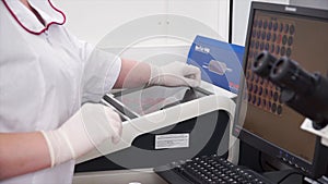 Female medical or scientific researcher using test tubes on laboratory. Clip. Female Scientist Analyzes Liquid in the