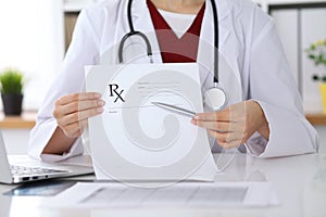 Female medicine doctor hand hold clipboard pad and give prescription to patient closeup. Panacea and life save