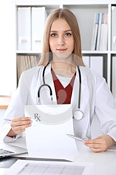 Female medicine doctor hand hold clipboard pad and give prescription to patient closeup. Panacea and life save