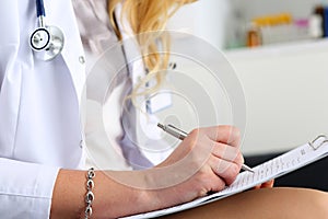 Female medicine doctor hand holding silver pen