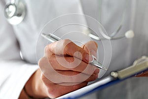 Female medicine doctor hand holding silver pen