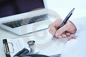 Female medicine doctor hand holding silver pen writing something on clipboard closeup.. Ward round, patient visit check