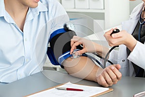 Female medicine doctor hands measuring blood pressure