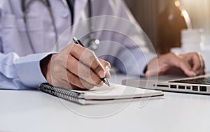 Female medicine doctor, physician or practitioner in lab room writing on blank notebook.