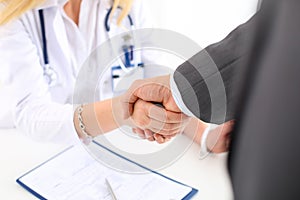 Female medicine doctor shake hand as hello