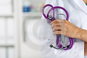 Female medicine doctor standing with hands crossed on her chest